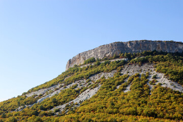 autumn in the mountains limestone cliff surrounded by colorful forest