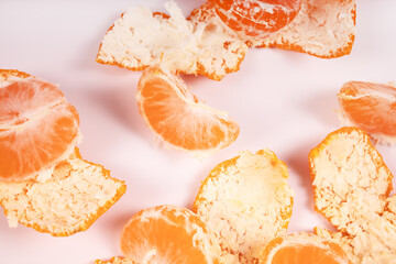 slices of tangerine are scattered among the peel chaotically