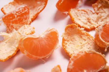 five slices of tangerine scattered among the peel