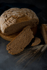 Homemade rye round bread on a dark background