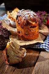 Easter cake kraffin. Kraffins with raisins, candied fruits and poppy seeds, sprinkled with powdered sugar. Close-up of homemade cake. Cruffin. Red colored eggs.
