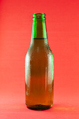 Beer bottle on red background