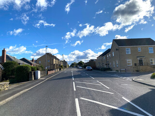 Fototapeta na wymiar View up, Scholes Lane, with houses, and vehicles in, Cleckheaton, Yorkshire, UK