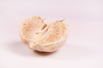 an angled view of a peeled half of a tangerine lying center up