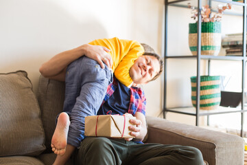 Obraz premium Father's day, happy family, boy and his dad at home