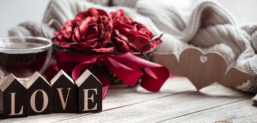 A romantic composition for Valentine's Day with the decorative word love and decor details.