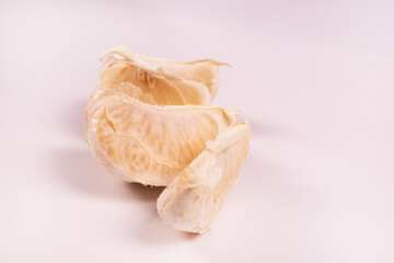 side view of a half of a tangerine divided into slices in the form of a snake