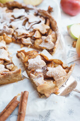 Traditional apple pie on the table with decorations.