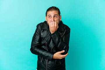 Fototapeta premium Young man with long hair look biting fingernails, nervous and very anxious.
