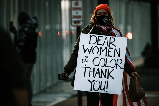 Person on the street with sign during presidential inauguration 