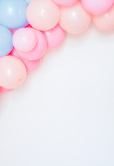 Colorful and joyful set of birthday balloons on a white wall.