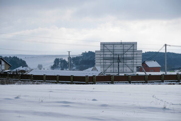 Solar panels in winter cloudy morning on a snowy field. Inside the solar panel. Copy space.