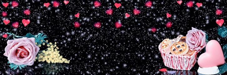 Chocolate heart, rose and cookies for Valentine's day, on a widescreen background with heart-shaped bokeh and snow