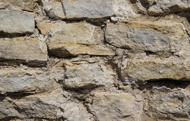 The texture of the stone wall of an architectural landmark