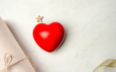 Red heart on white cement background.