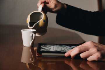 A man eats breakfast while reading