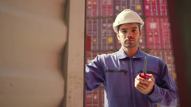 Caucasian senior worker docker hand open container cargo for checking examine product,logistics worker wear safety helmets and protect suite open cargo container door and working and checking process