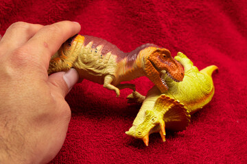 Plastic dinosaur toys in red background