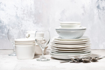 tableware, cutlery and kitchen utensils on white table