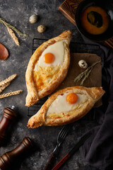 Traditional Adjarian khachapuri pies with salted cheese and egg