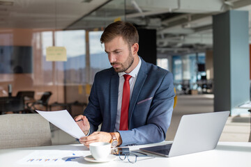 Businessman working in the office and reading documents.
