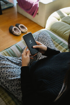 Girl Watching Tik Tok On The Mobile At Home