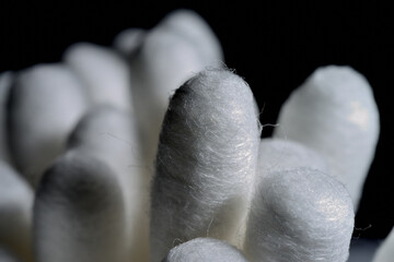 cotton swabs on black background