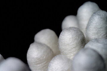 cotton swabs on black background