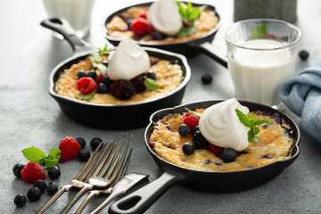 Berry crumble baked in small cast iron pans, individual desserts