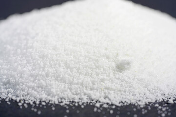 Makrogol powder photographed against a black background in the studio