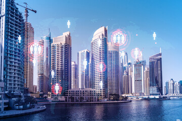 Obraz premium Skyscrapers of Dubai business downtown. International hub of trading and financial services. Social network icons hologram, concept of human resources. Double exposure. Dubai Canal waterfront.