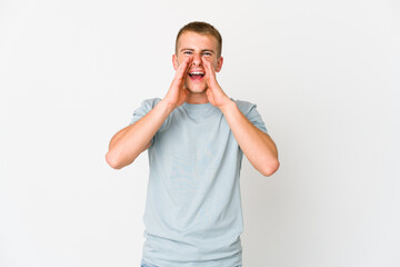 Young caucasian handsome man shouting excited to front.