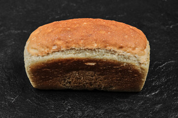 Square loaf of bread isolated on dark background