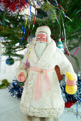 Slavic Grandfather Frost with a bag of gifts in his hand near the New Year tree