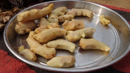 Fresh peeled ginger roots in a steel plate. Indian Zingiber officinale (adarak) used as a spice and a folk medicine