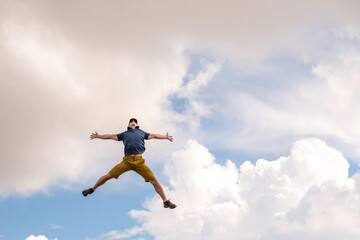 Fototapeta na wymiar A man jumping against the sky