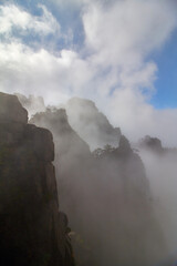 Fototapeta premium Berg im Nebel mit Sonnenschein