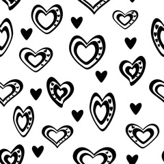 Seamless vector pattern. Stylized black and white hearts mixed with black hearts are scattered. On a transparent background.