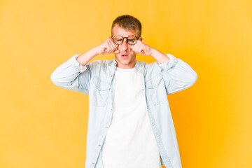 Young caucasian handsome man whining and crying disconsolately.