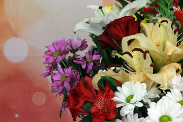 Bouquet of flowers varied in a glass vase on a background of sparkles and a wooden base