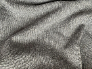 Grey creased synthetic fabric. Material for clothes.
