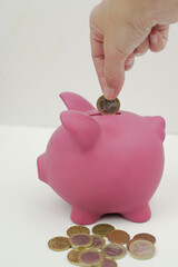 pink piggy bank with money to save