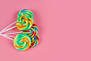 Several colorful lollipops on pink background