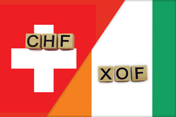 Switzerland and Cote d'Ivoire currencies codes on national flags background