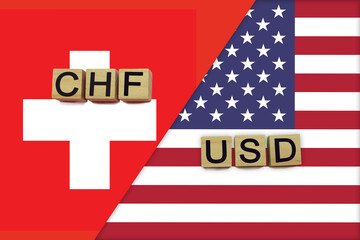 Switzerland and USA currencies codes on national flags background