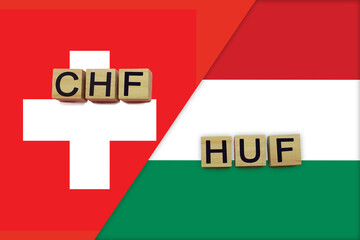 Switzerland and Hungary currencies codes on national flags background