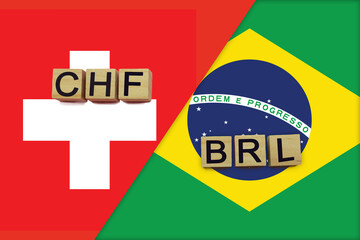 Switzerland and Brazil currencies codes on national flags background