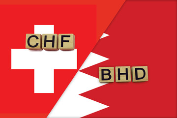 Switzerland and Bahrain currencies codes on national flags background