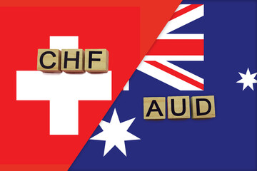 Switzerland and Australia currencies codes on national flags background