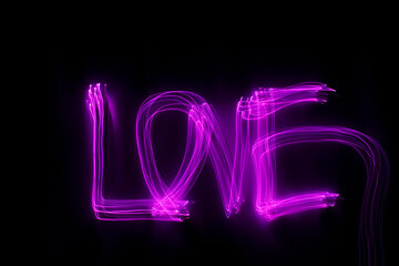 'Love' word written in pink light on black background. Long exposure 
neon light photograph. February 14 Valentine's Day concept. Neon wallpaper.